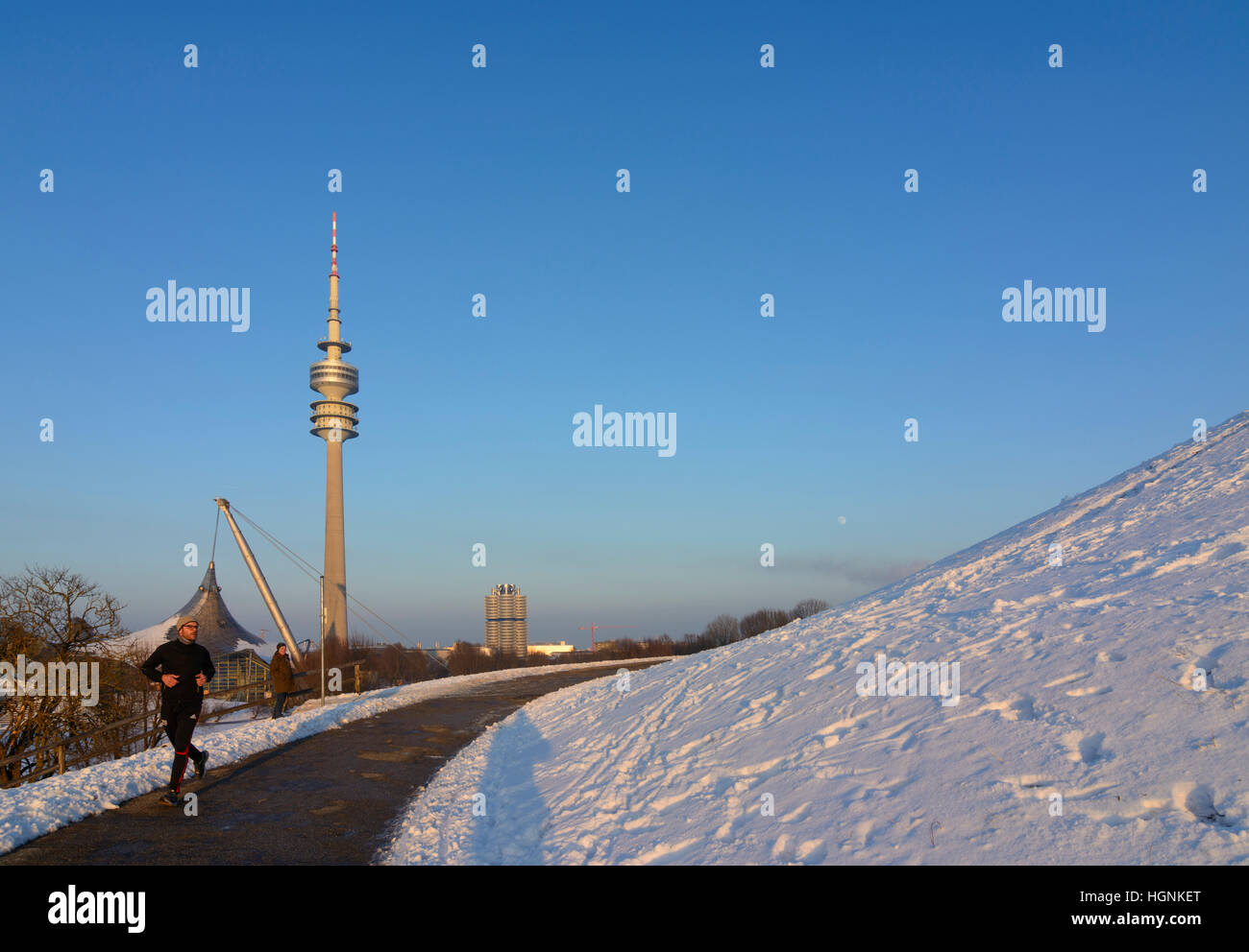 München, Munich: Olympiapark (Olympic Park), Olympiaturm (Olympic tower), man jogging, Oberbayern, Upper Bavaria, Bayern, Bavaria, Germany Stock Photo