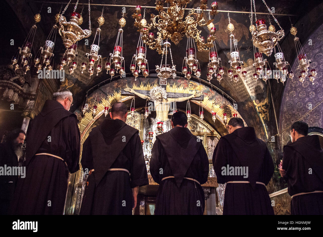 Jerusalem, Israel - July 18, 2014: Franciscan monks pray by the Crucifixion Altar in the Church of Holy Sepulchre during via Dolorosa precession. Stock Photo