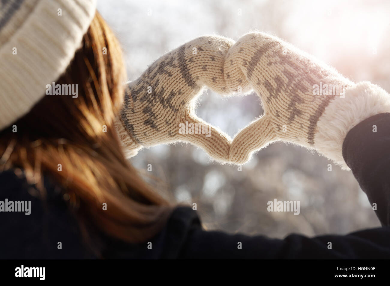 Woman holding hands in a heart shape Stock Photo
