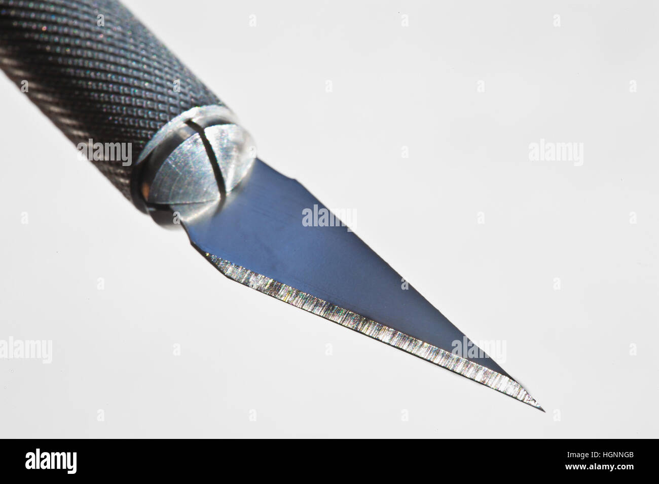 macro of xacto knife blade and handle on white backgrouond Stock