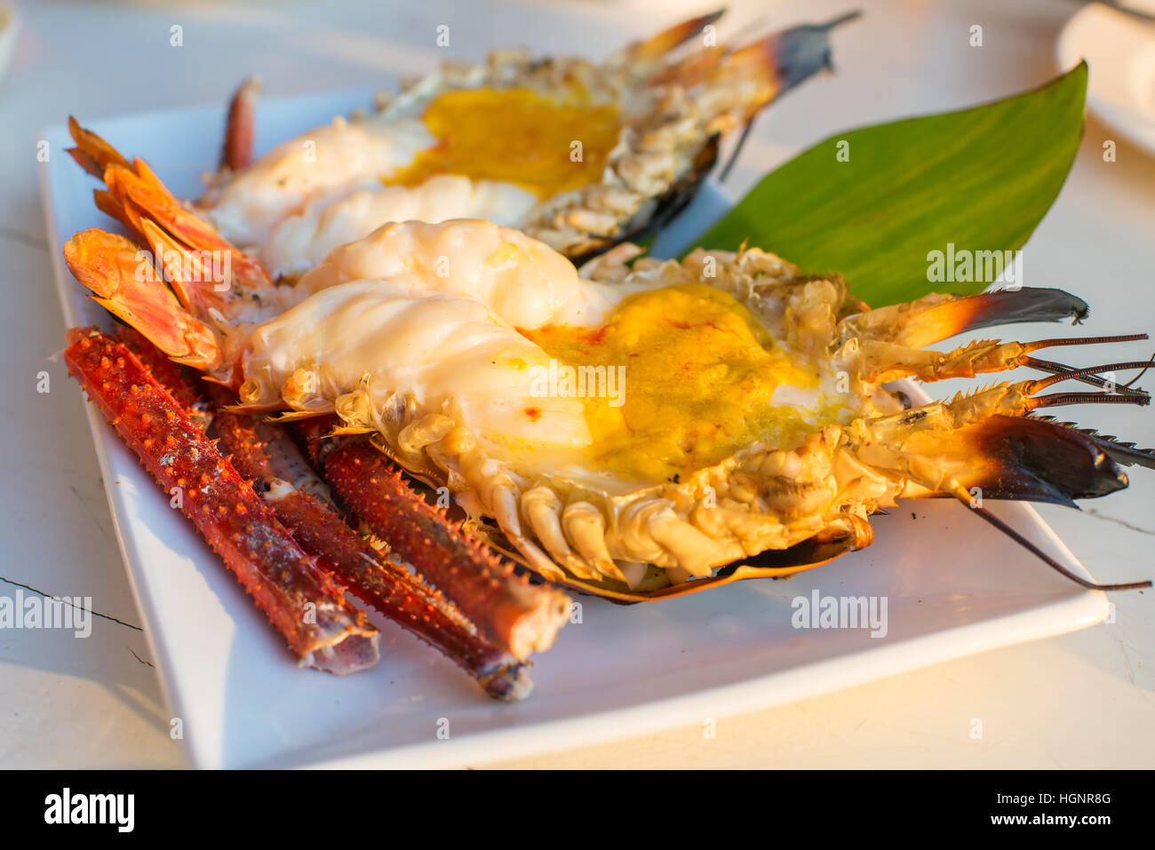 grilled river giant prawn with spicy seafood sauce inwhite disk Stock