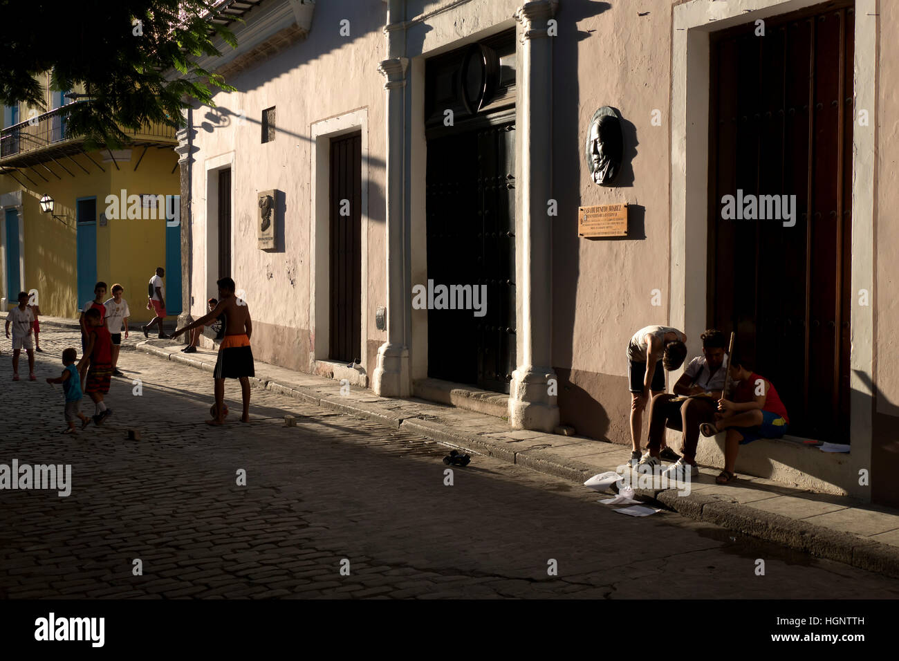 Havana, Cuba. Boys and sport, happy Cuban kids playing football in city street, team of children, friends and soccer game Stock Photo
