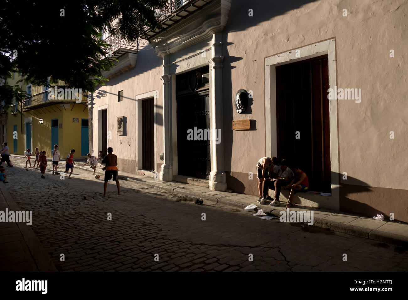 Havana, Cuba. Boys and sport, happy Cuban kids playing football in city
