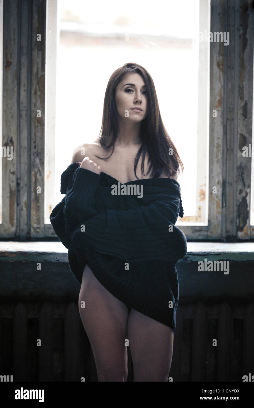 Woman portrait in black pullover with window behind Stock Photo