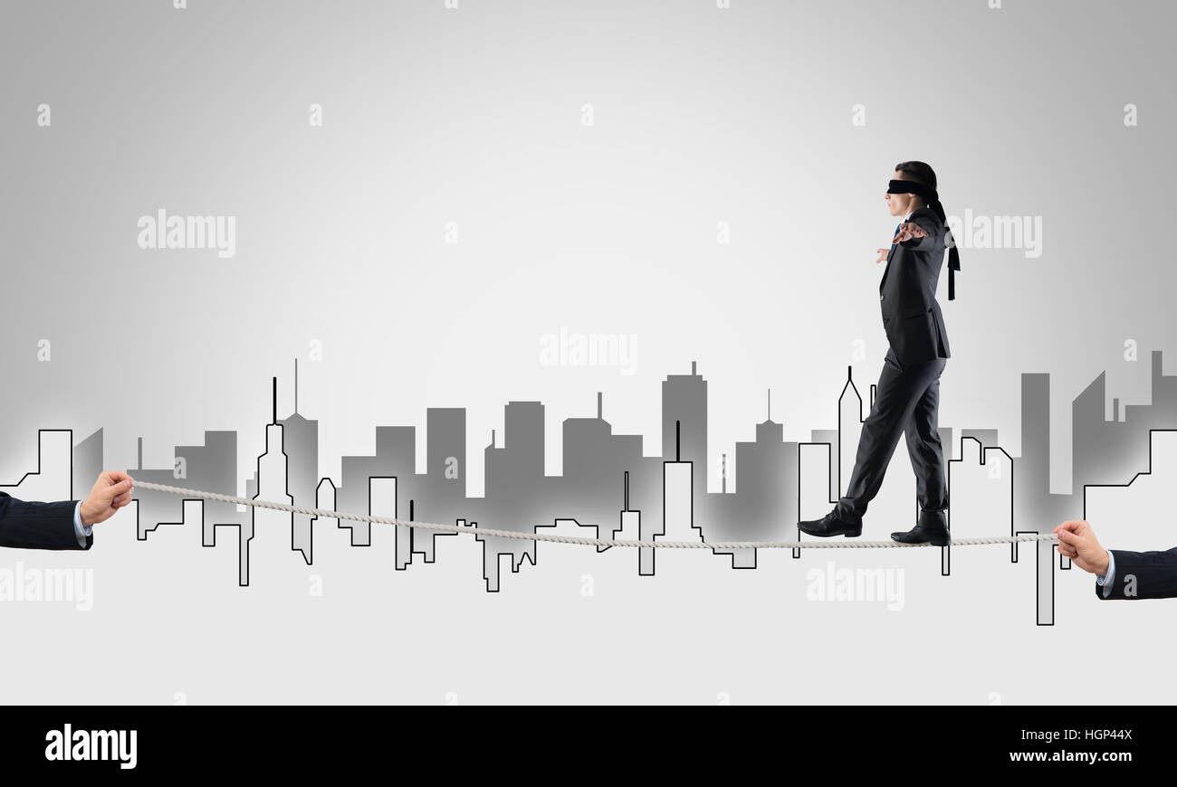 Business concept of risk support and assistance with man balancing on ...