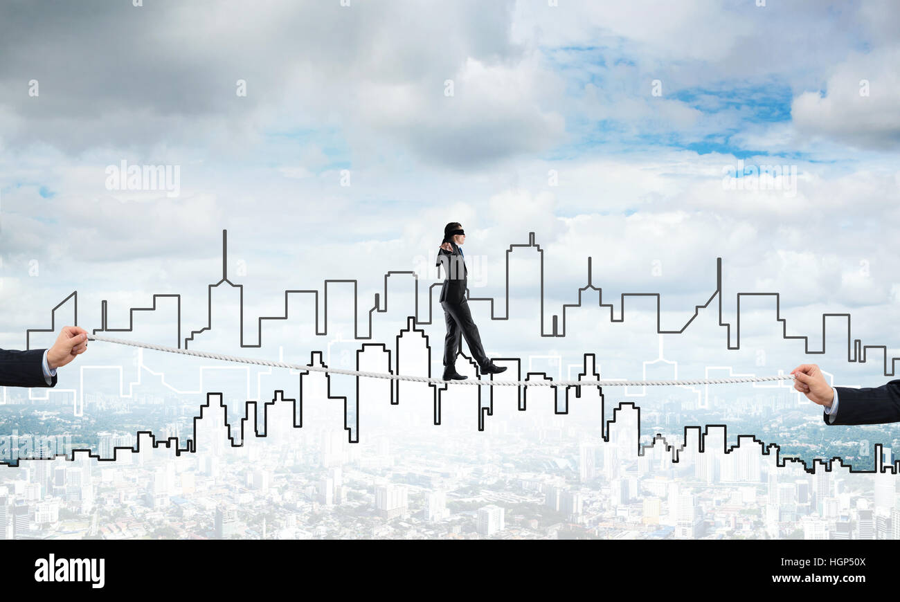 Business concept of risk support and assistance with man balancing on ...