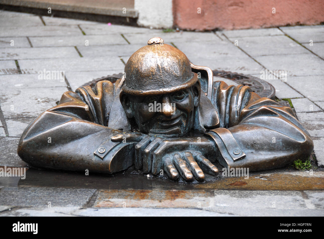 Bronze statue 'The watcher' or Cumil, junction of Laurinská and Panská Street, Bratislava, Slowakia Stock Photo