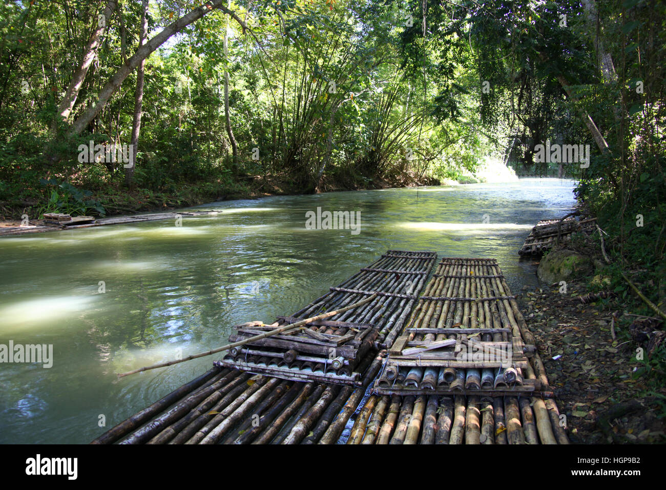 Bamboo rafts prepared & ready for a popular tourist day trip on the Martha Brae river, Falmouth, Jamaica. Close to Montego Bay & Ocho Rios. Stock Photo