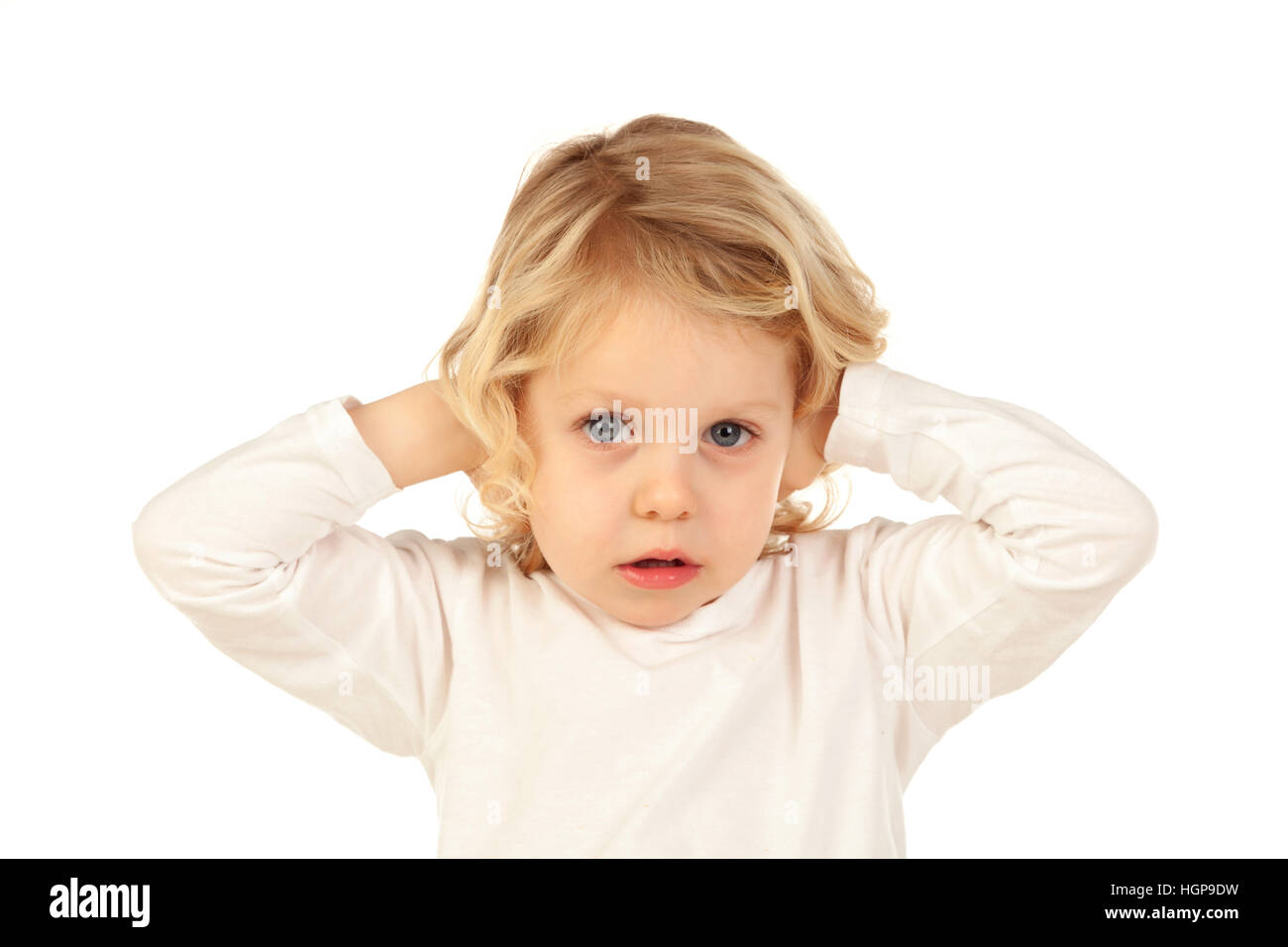 Little kid covering the ears isolated on a white background Stock Photo