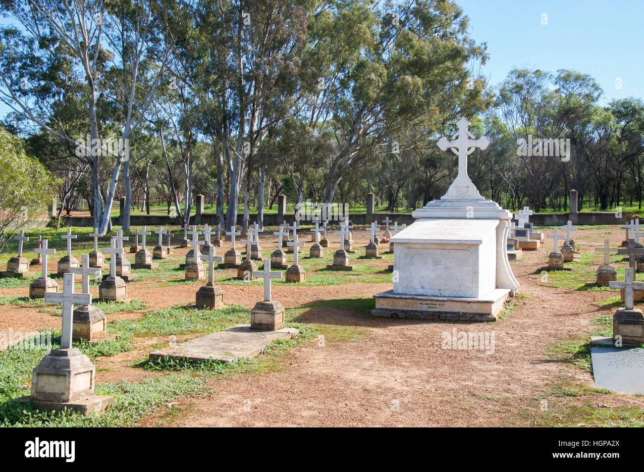 Large above ground tomb with rows of graves with white crosses in the ...