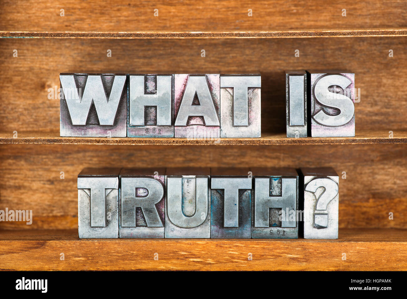 what is truth question made from metallic letterpress type on wooden tray Stock Photo