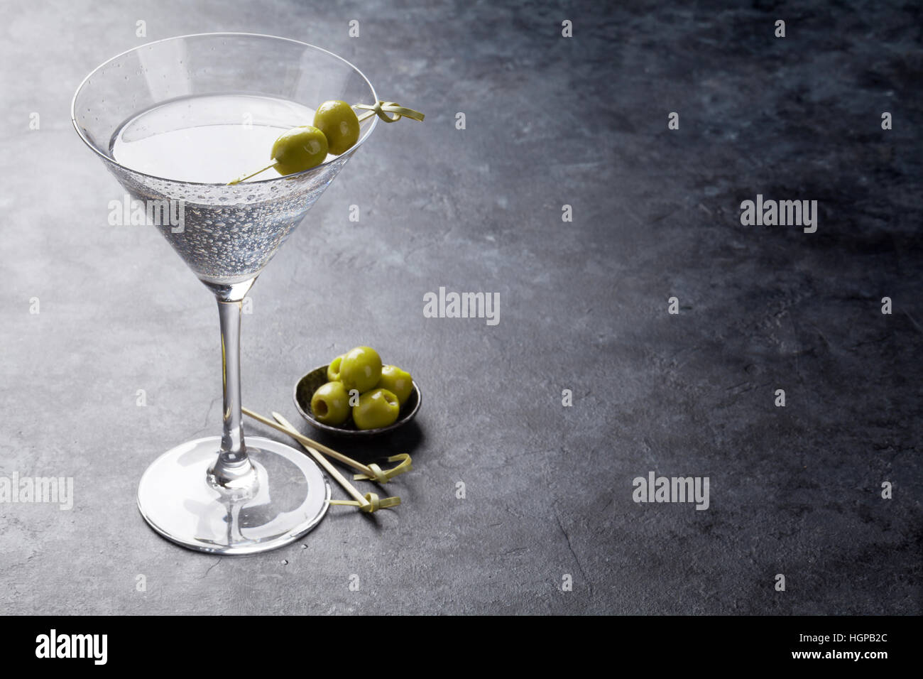 Martini cocktail on dark stone table. With space for your text Stock Photo