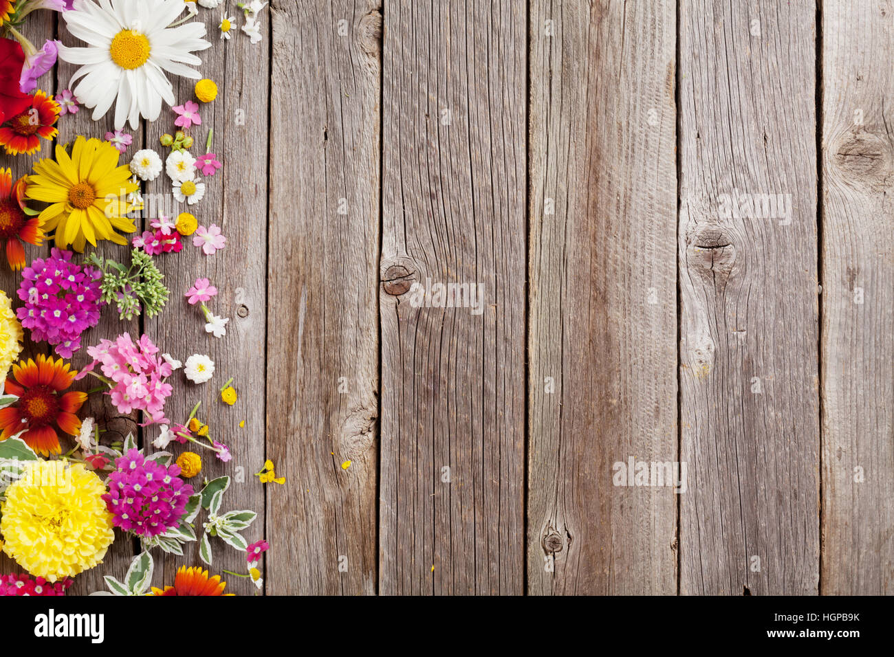 Garden flowers over wooden table background. Backdrop with copy space