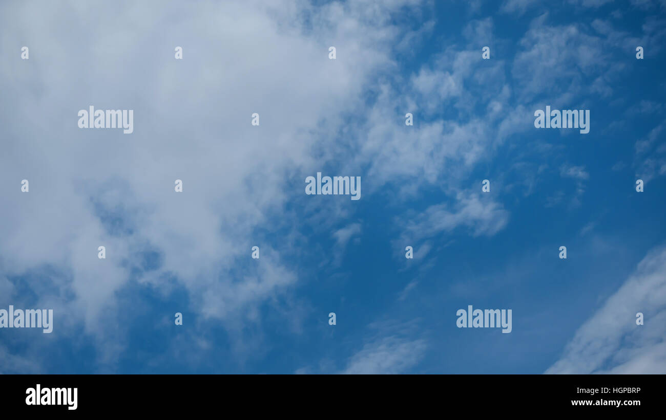 White fluffy clouds on a blue sky background Stock Photo - Alamy