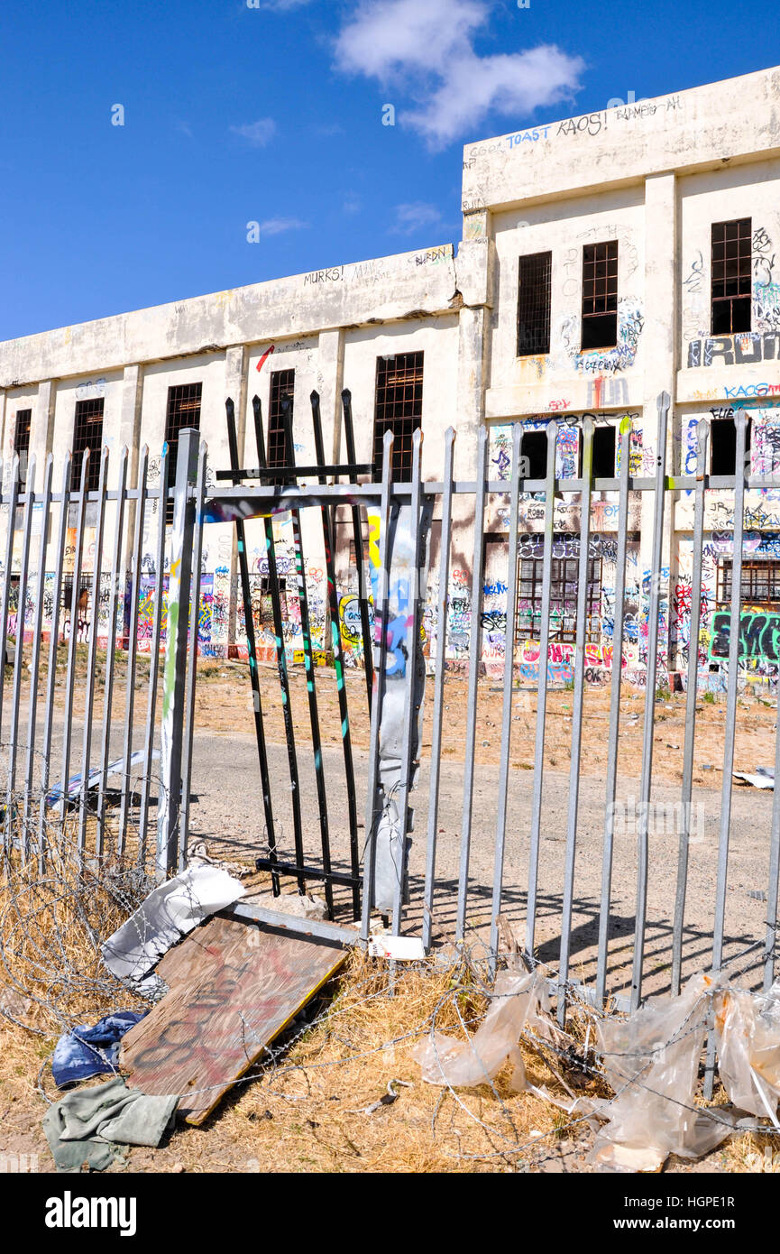 Old abandoned South Fremantle Power Station with youth tagging, broken windows and fence gate in