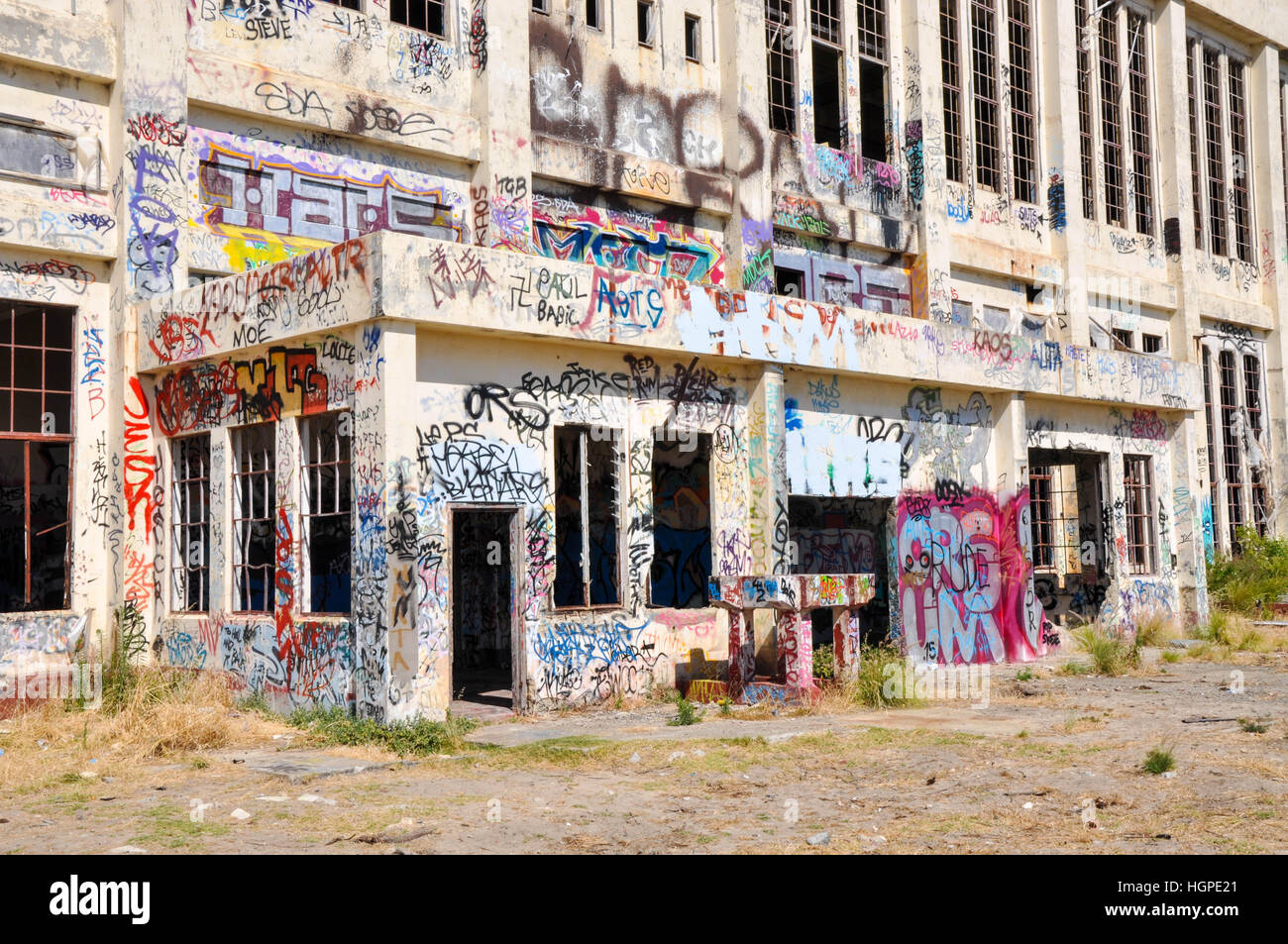 Old abandoned South Fremantle Power Station with youth tagging, broken windows and empty shell