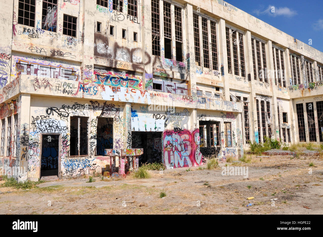 Old abandoned South Fremantle Power Station with youth tagging, broken windows and empty shell