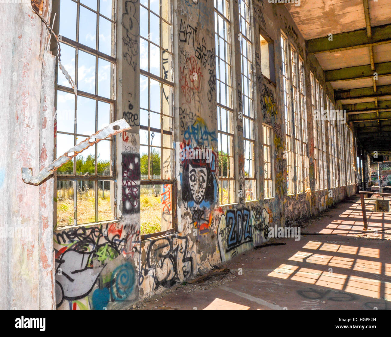 Old abandoned South Fremantle Power Station with youth tagging, broken windows and empty shell