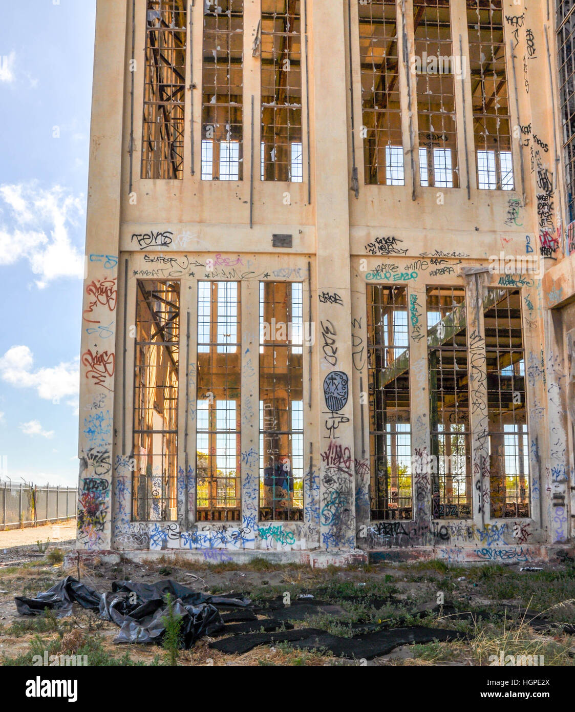 Old abandoned South Fremantle Power Station with youth tagging, broken windows and empty shell