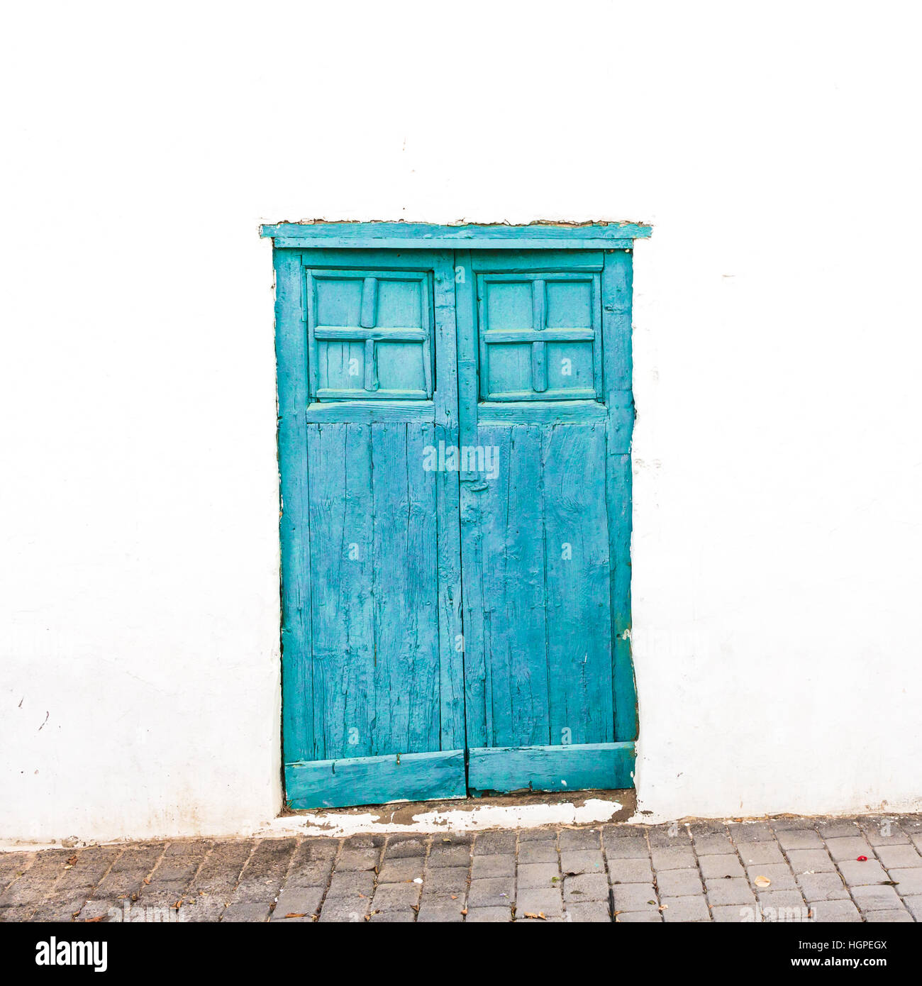 house white wall with blue door Stock Photo