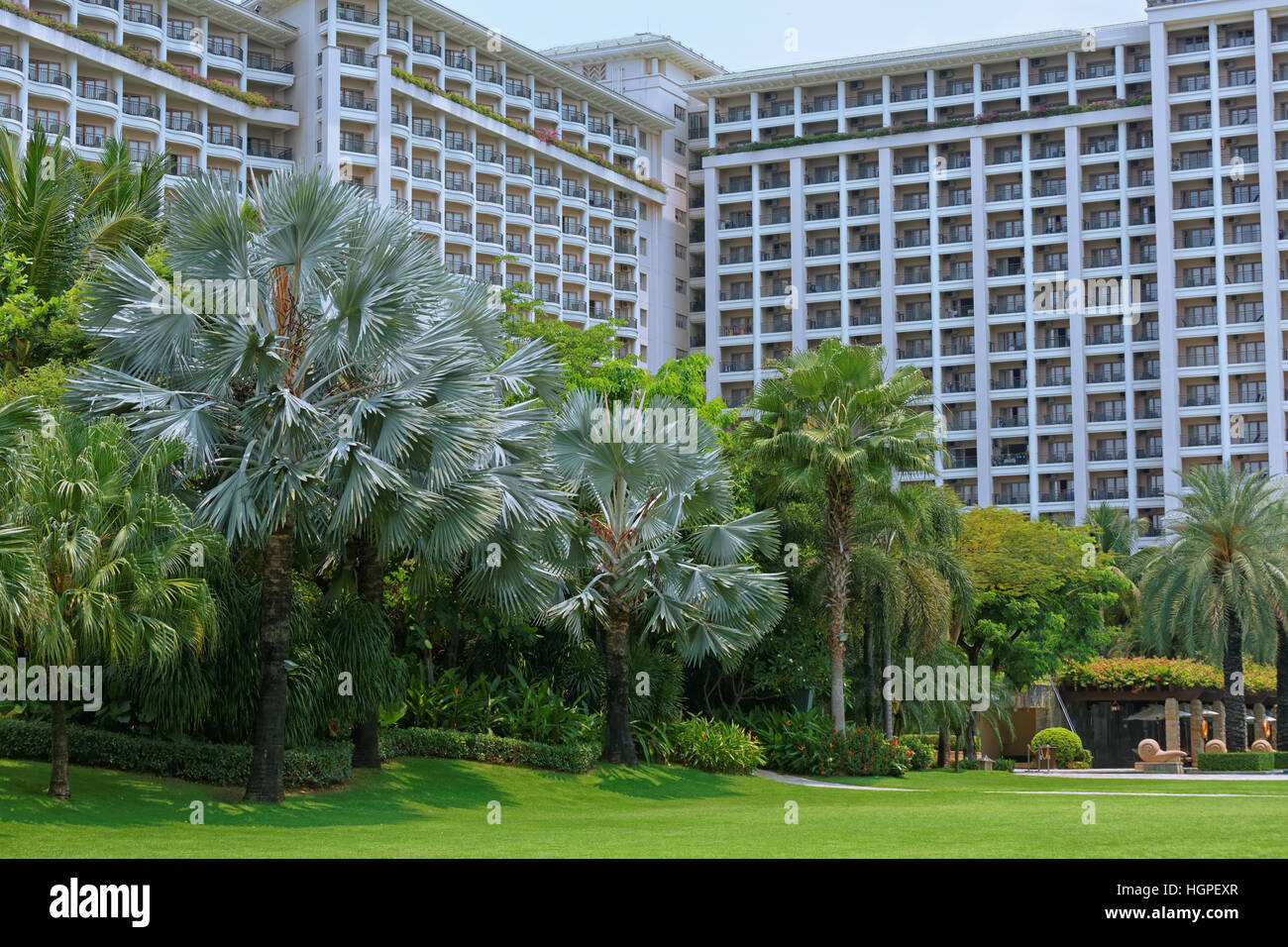 Large hotel with large garden of tropical trees. Stock Photo