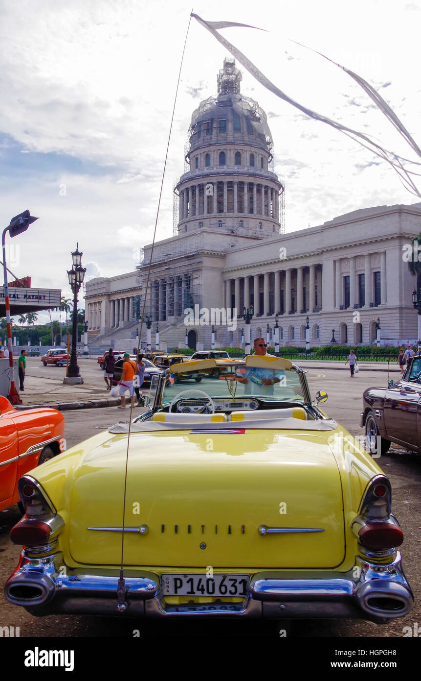 El Capitolio or National Capitol Building in Havana, Cuba, with an old Pontiac in the foreplan Stock Photo