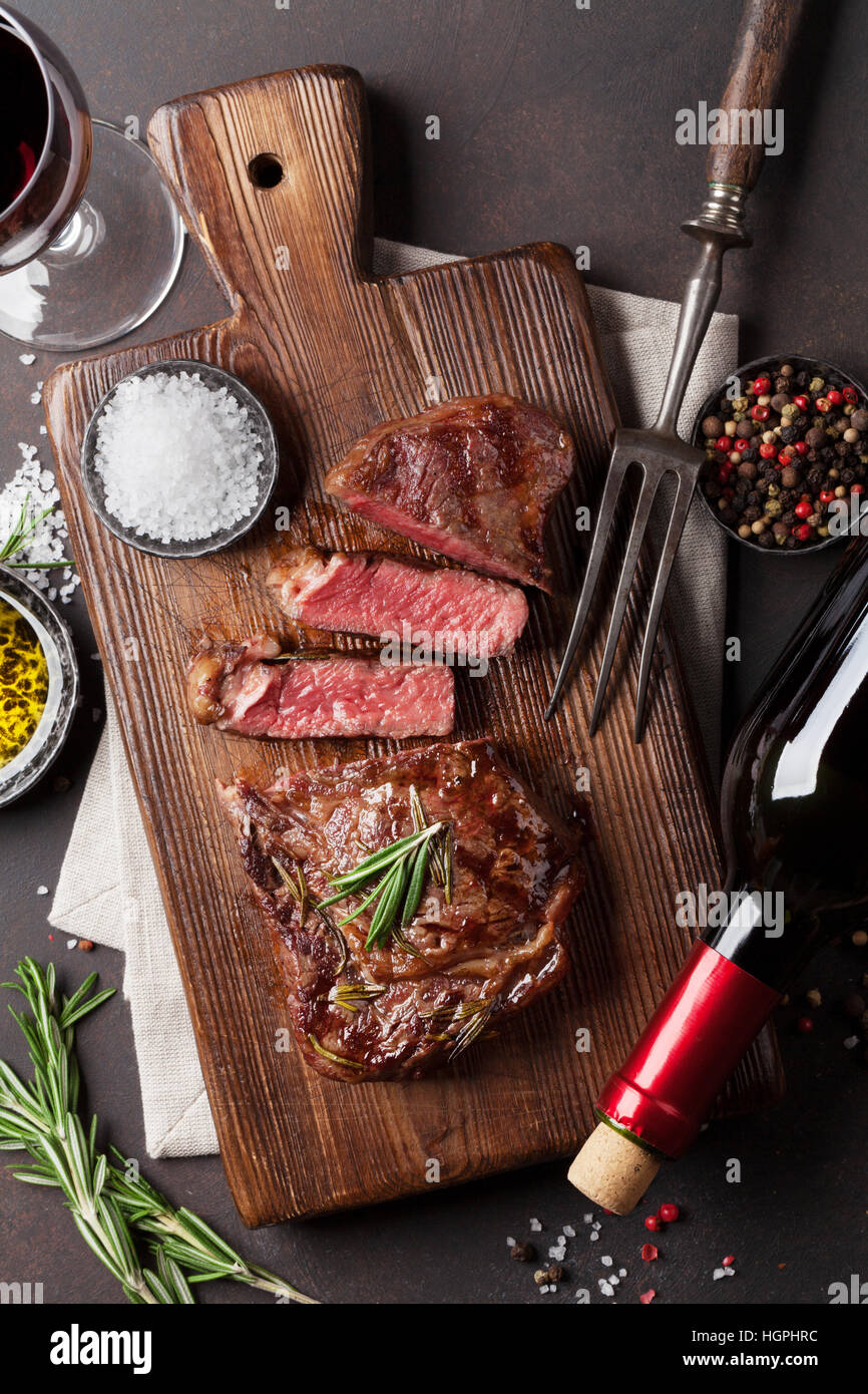 Grilled ribeye beef steak with red wine, herbs and spices. Top view ...