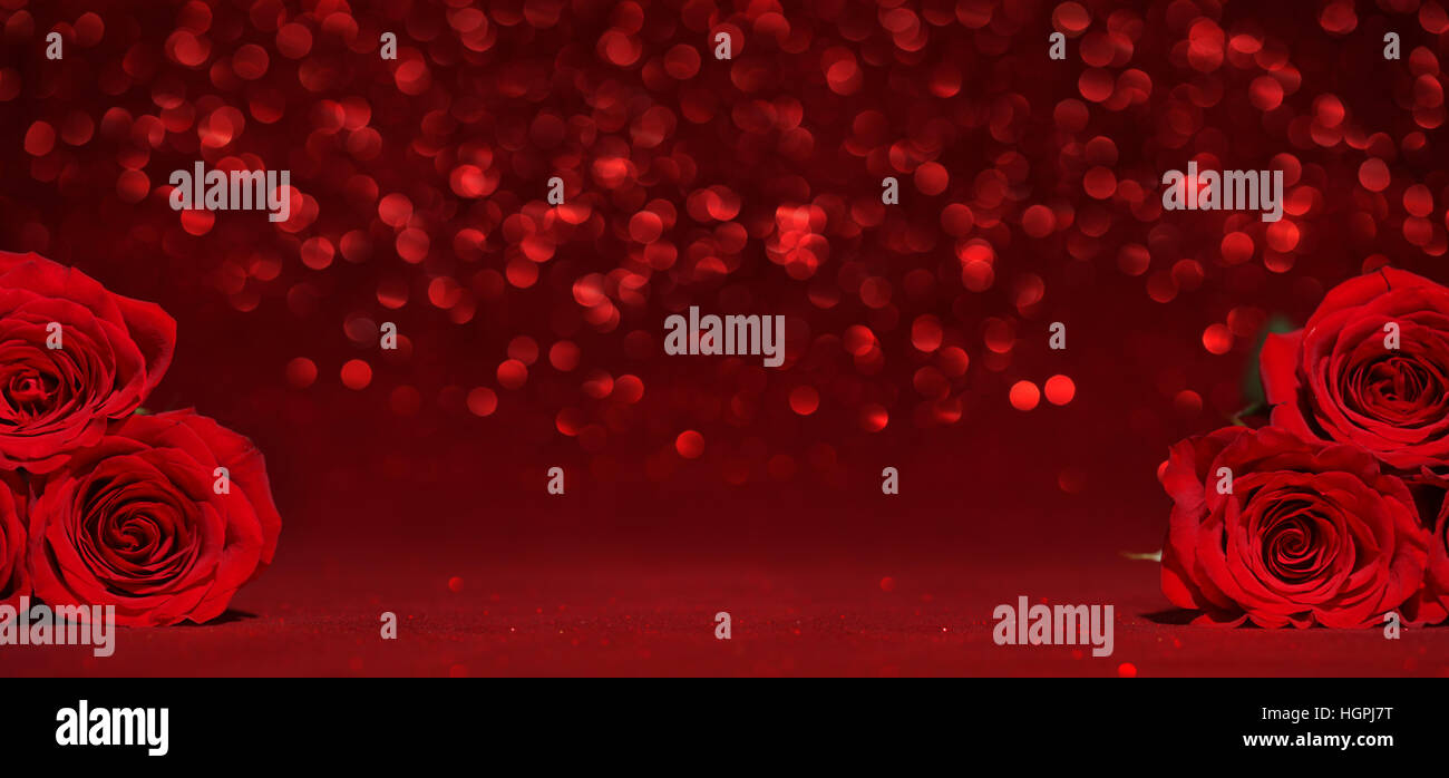 Beautiful red roses on sparkling red background Stock Photo - Alamy