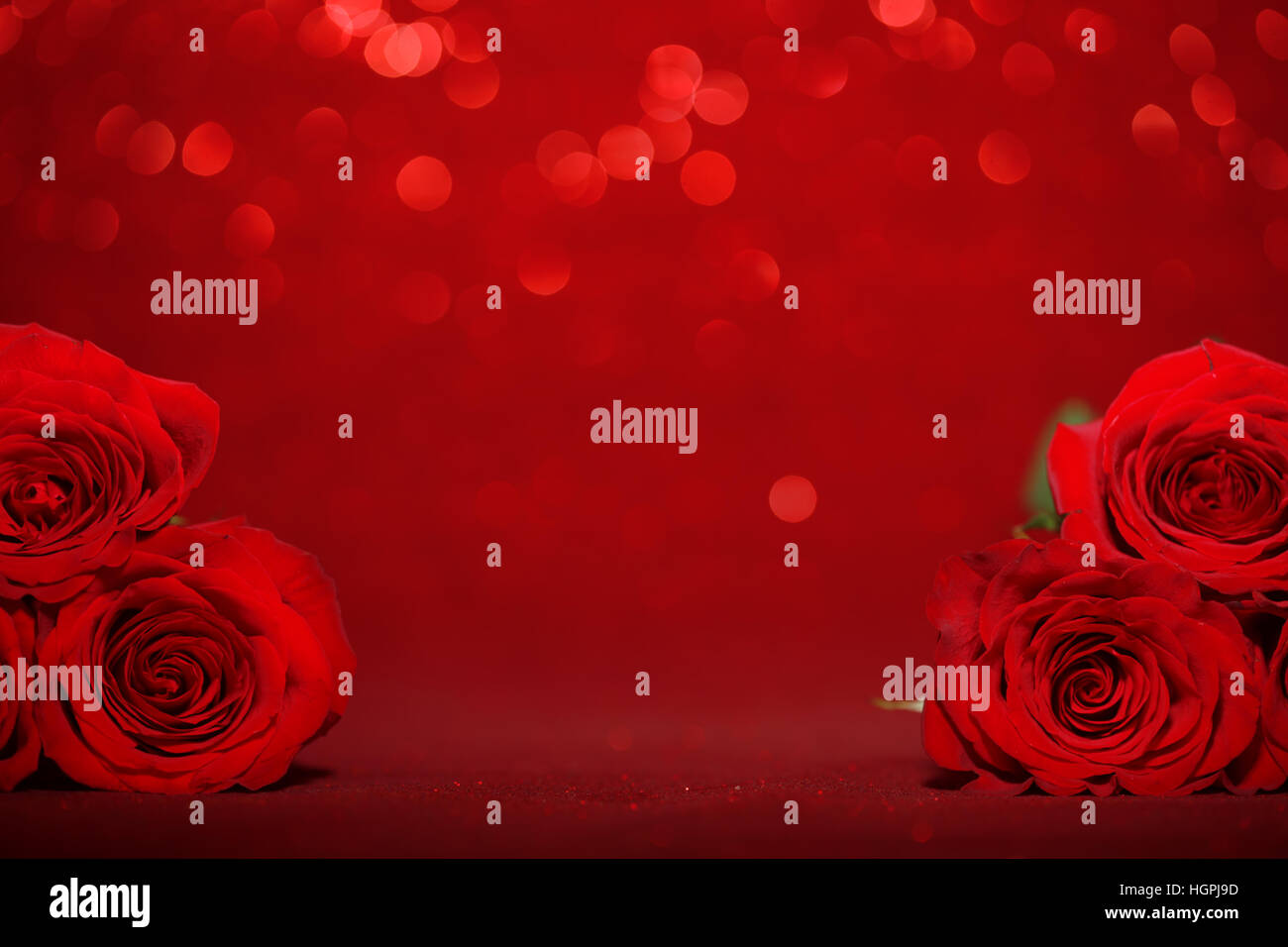 Beautiful red roses on sparkling red background Stock Photo - Alamy