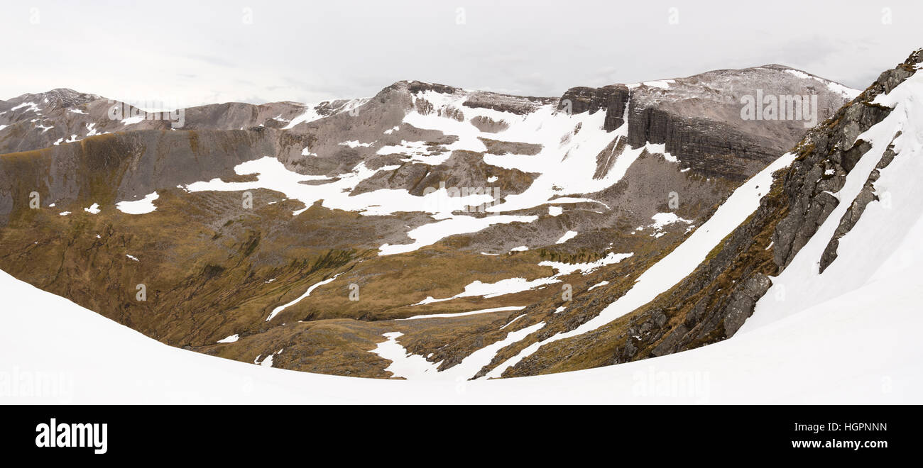 The grey corries covered in snow and ice in early summer from beinn na soccaich near fort william and ben nevis, scotland, uk Stock Photo