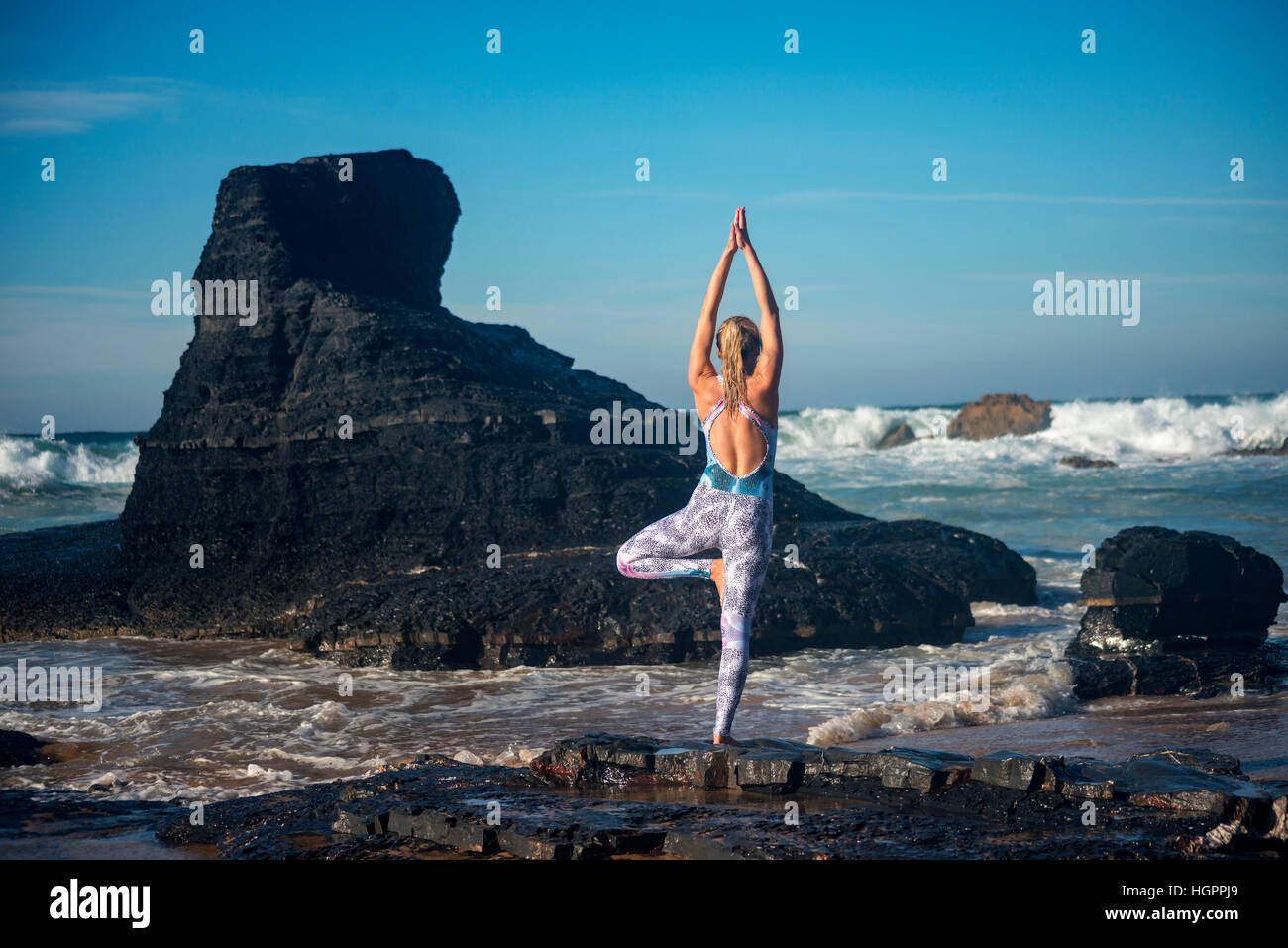 woman doing yoga at the beach Stock Photo