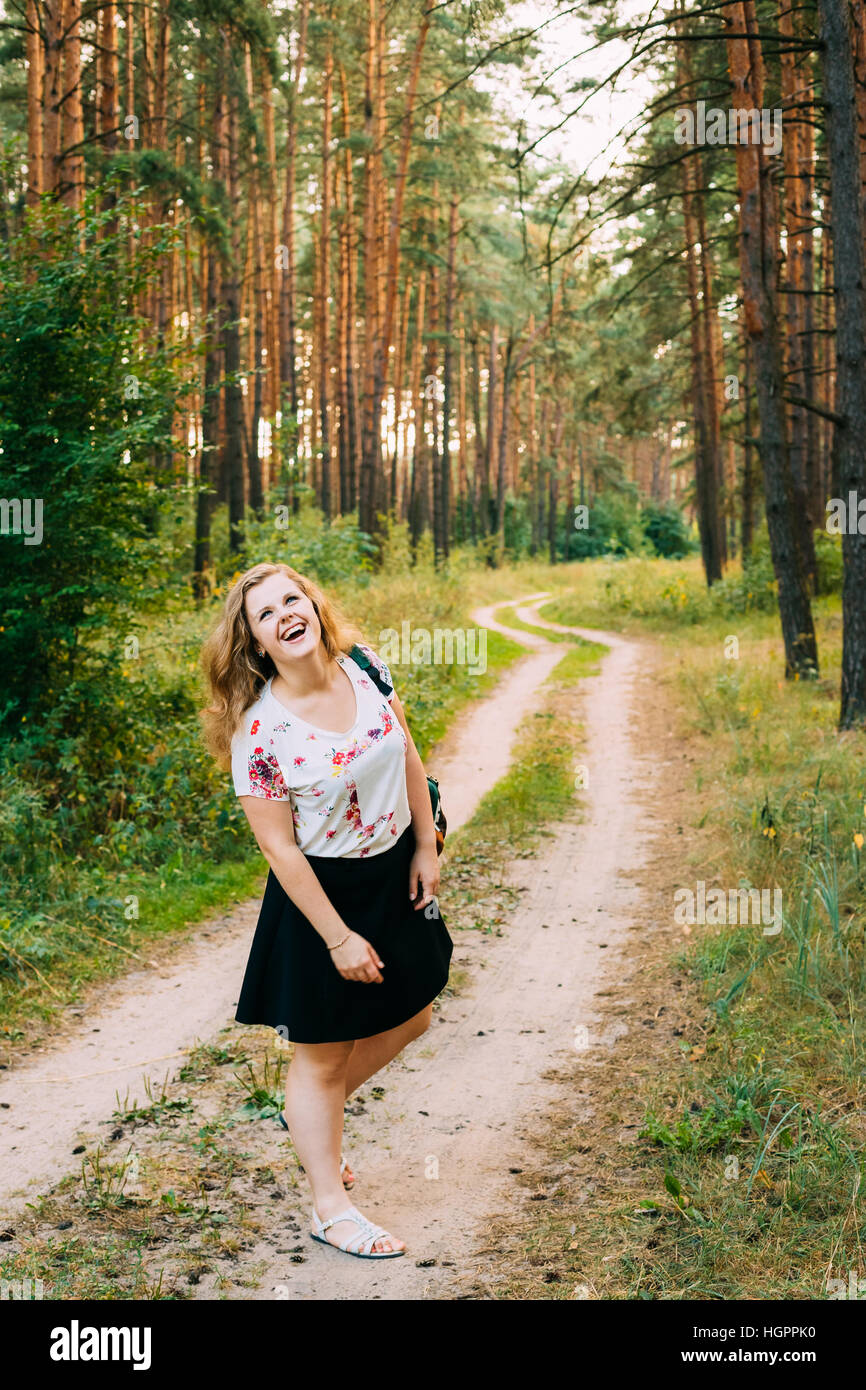 Young Pretty Plus Size Caucasian Happy Smiling Laughing Girl Woman With Wavy Brown Long Hair In White T-Shirt And Black Short Skirt Standing Full-Leng Stock Photo