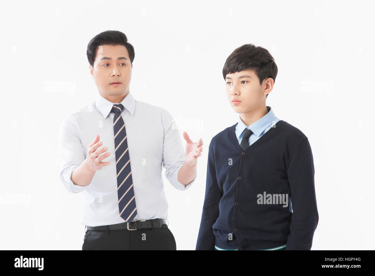 Teacher talking and stressful school boy Stock Photo