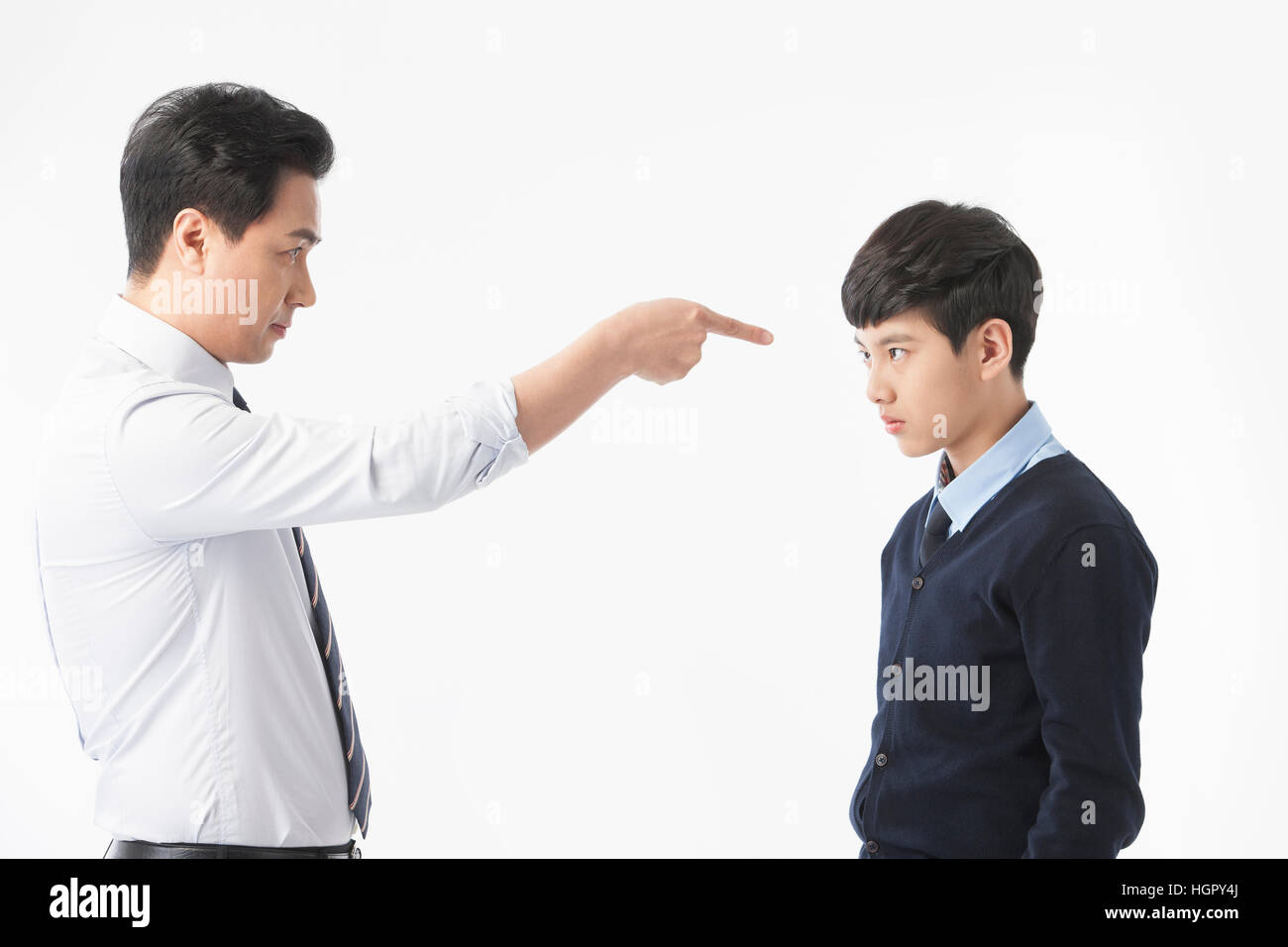 Side view of teacher scolding and stressful school boy Stock Photo - Alamy