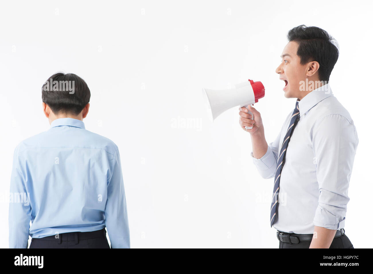 Teacher scolding a school boy Stock Photo