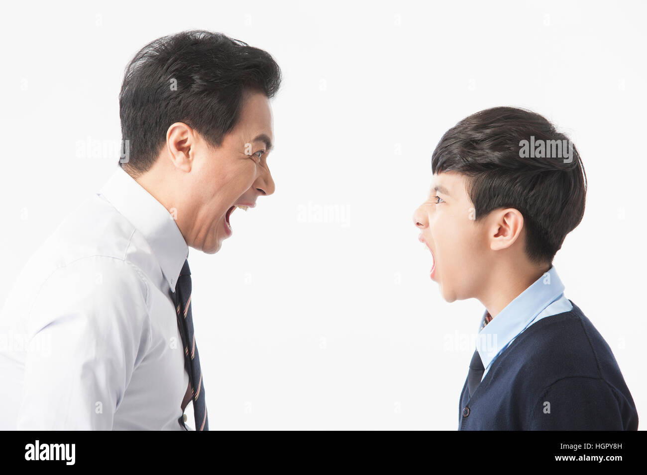 Side view portrait of teacher and school boy yelling at each other Stock Photo