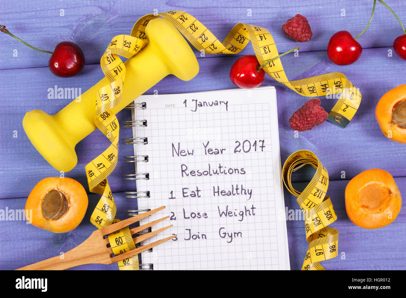 New year resolutions or goals written in notebook, fresh fruits