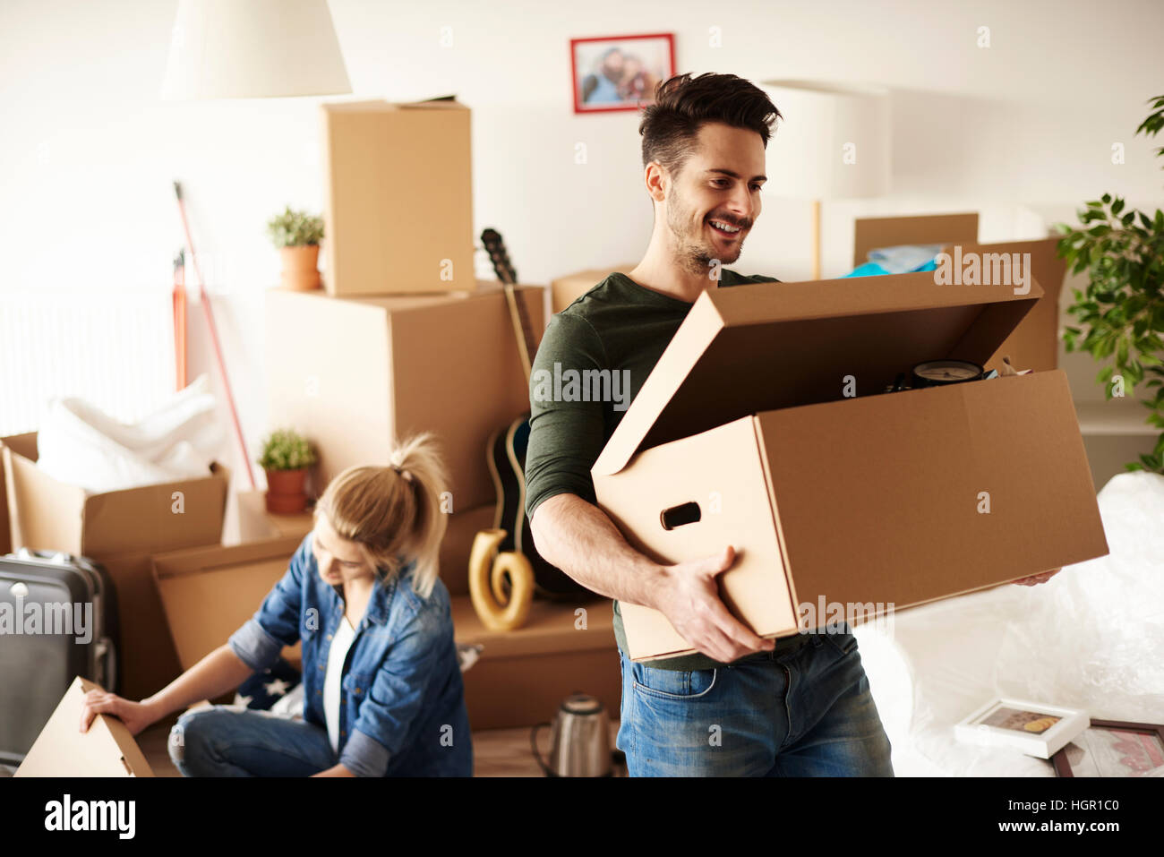 Young couple moving in to house Stock Photo