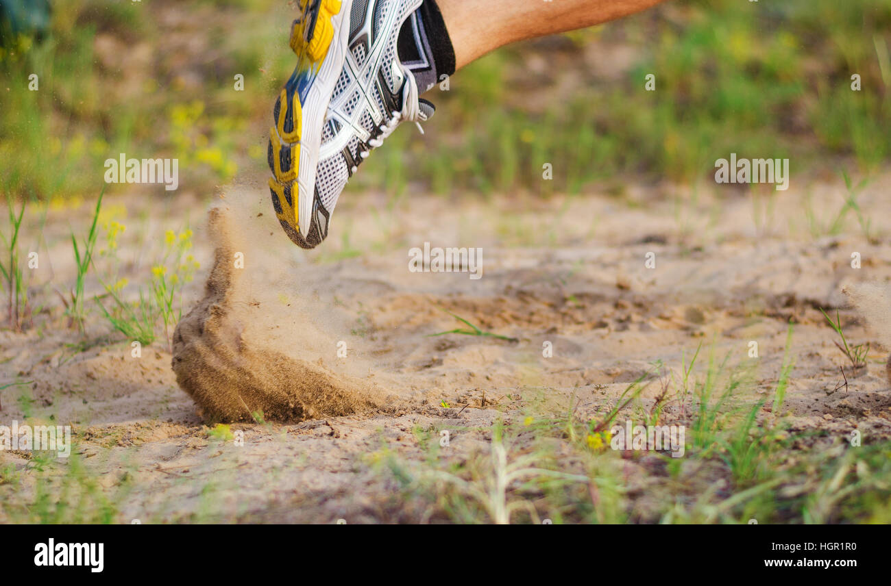 Athlete's foot in sneakers which starts to run. Sand flies under their