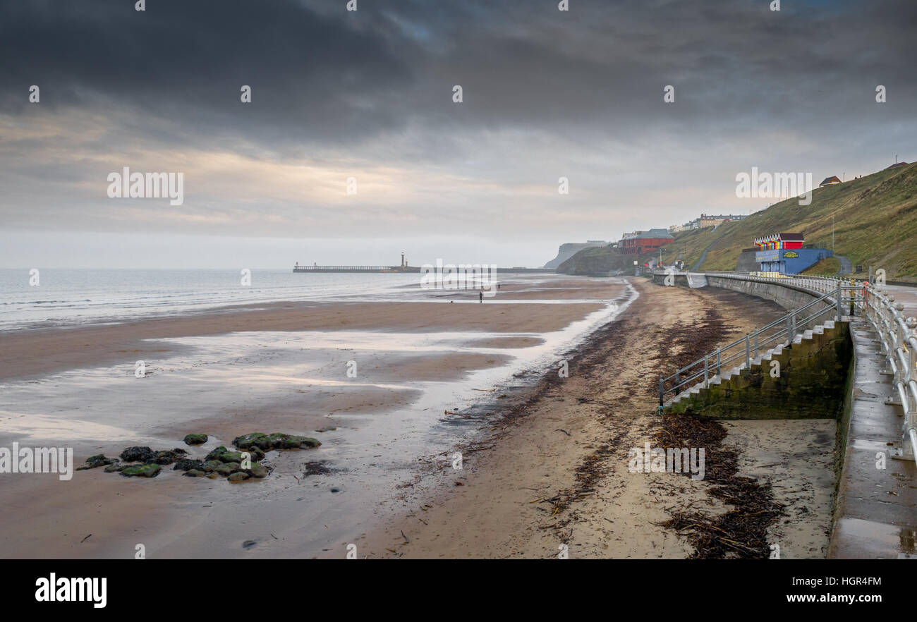 The harbour entrance to Whitby with lighthouses and sea defenses, Yorkshire, England, U.K. Stock Photo