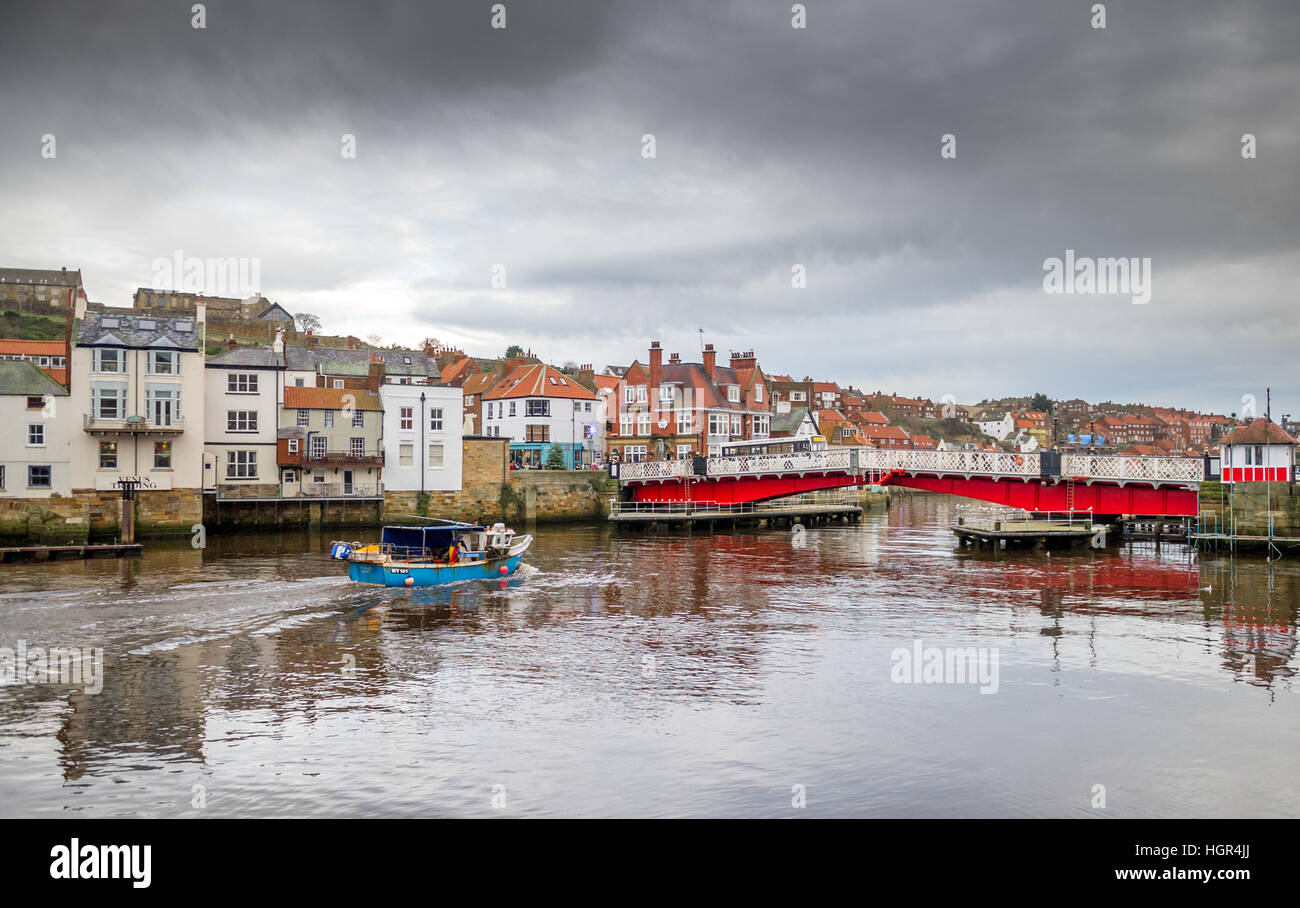 Small fishing boat enters the harbour of the town of Whitby Stock Photo ...