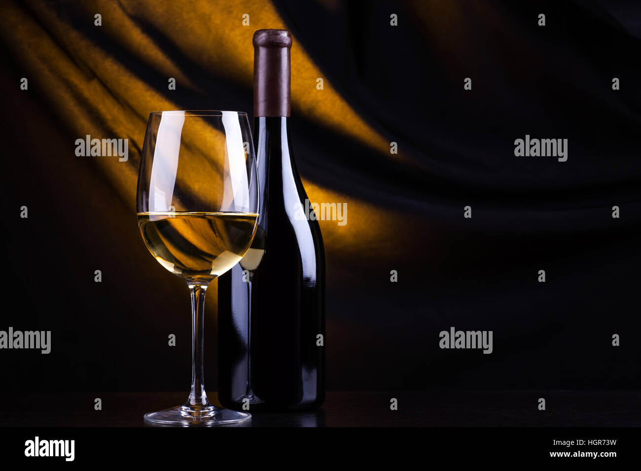 Download Glass And Bottle Of White Wine With A Dark Background Lit By A Yellow Stock Photo Alamy Yellowimages Mockups