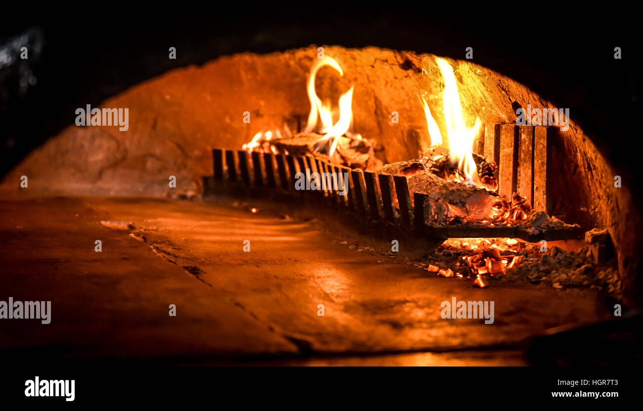 Traditional old Pizza oven with natural firewood, coal and flame is ready for backing Stock Photo