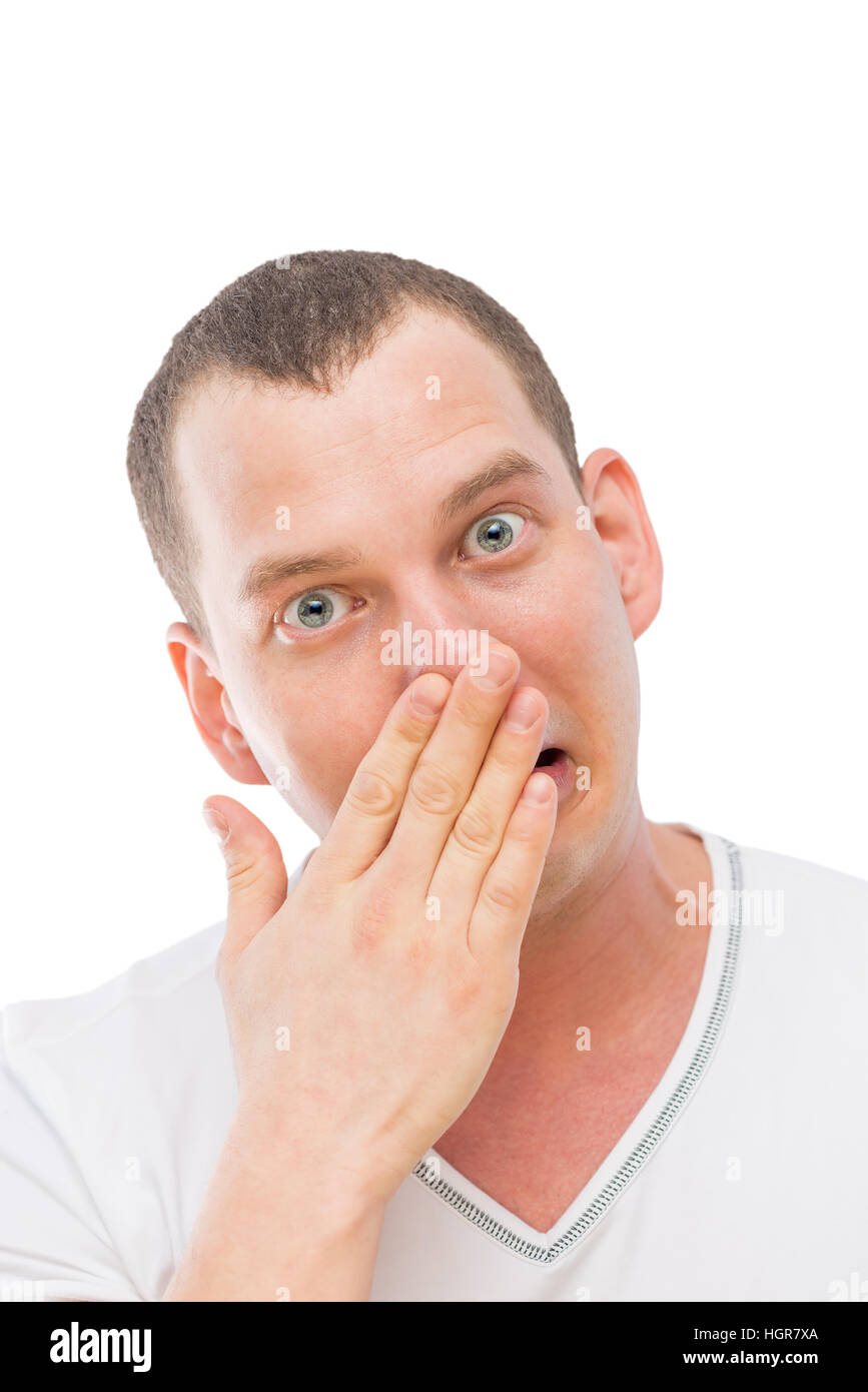 a young man makes a face, rubbing his nose with his hand isolated Stock