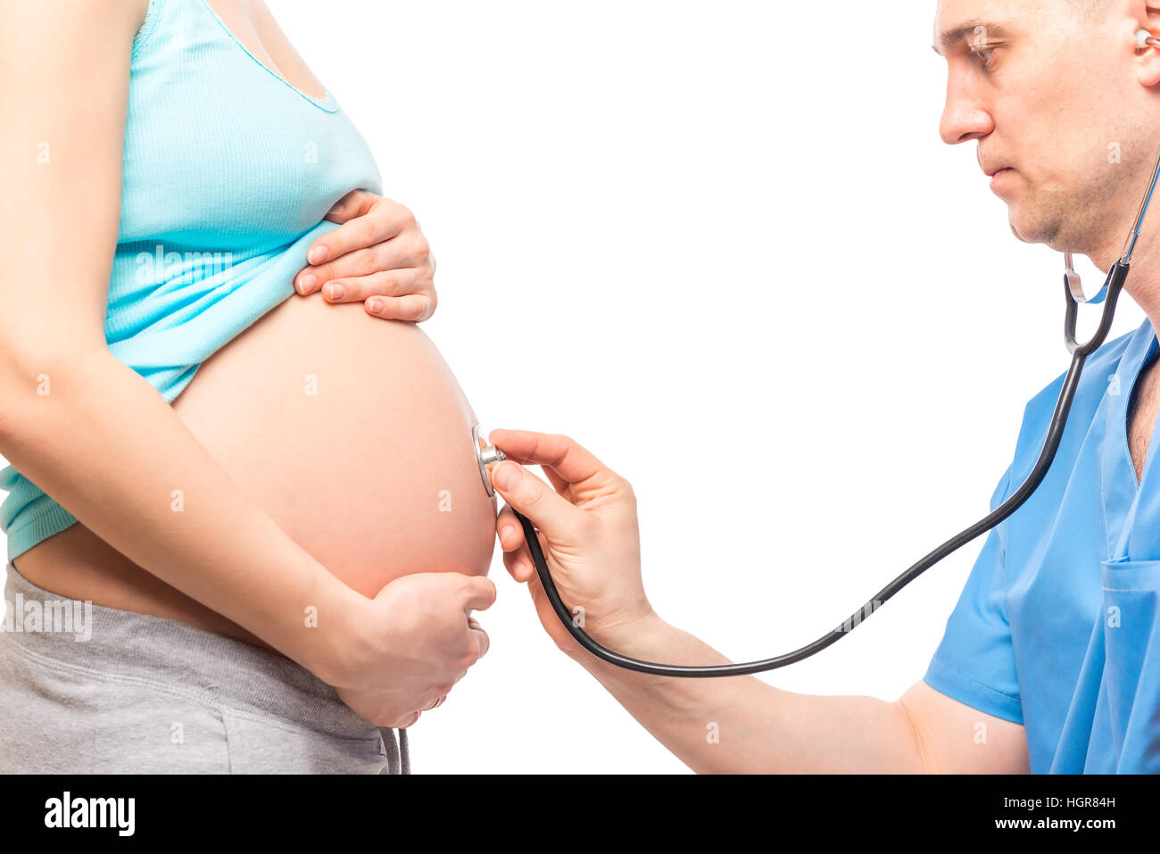 Doctor listening the baby's heartbeat in the belly of a pregnant woman