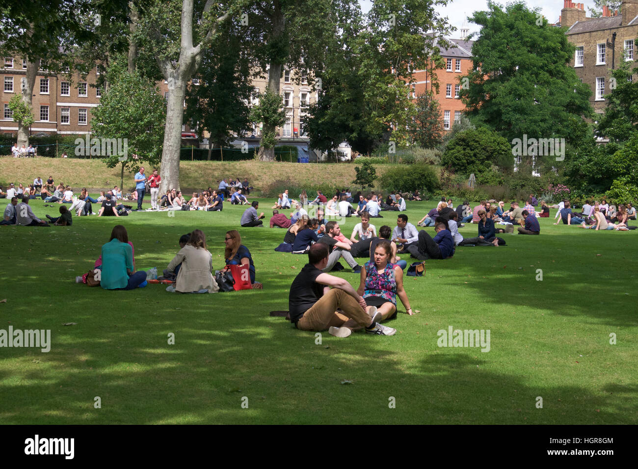 People enjoying the sunshine in Gray's Inn Gardens, London Stock Photo