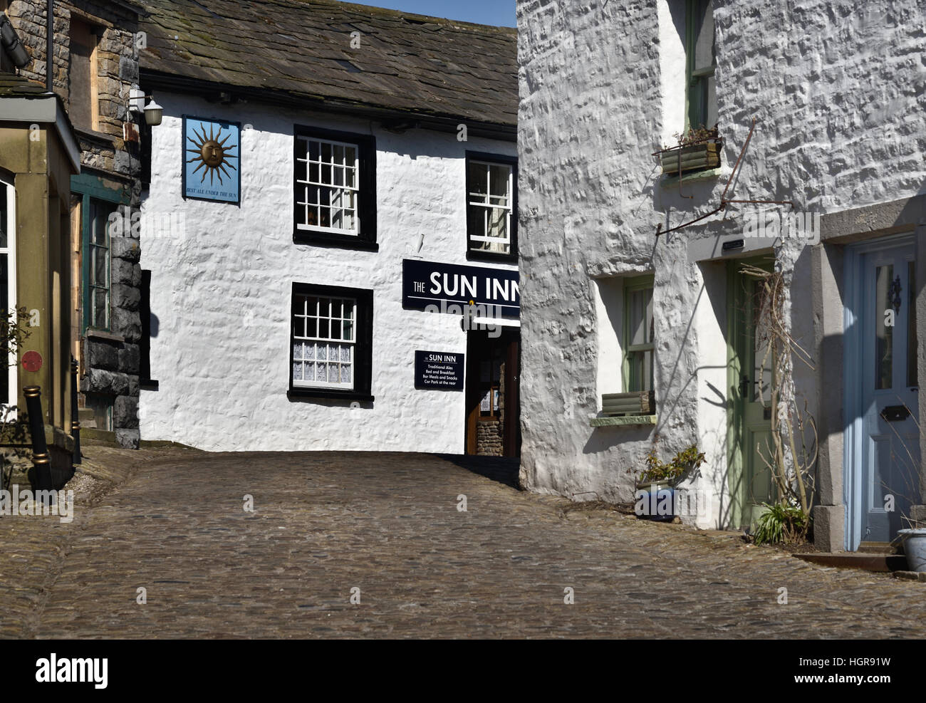 Cobbled Main Street, Dent village, looking towards the Sun Inn, Yorkshire Dales National Park, Cumbria, England, UK. Stock Photo
