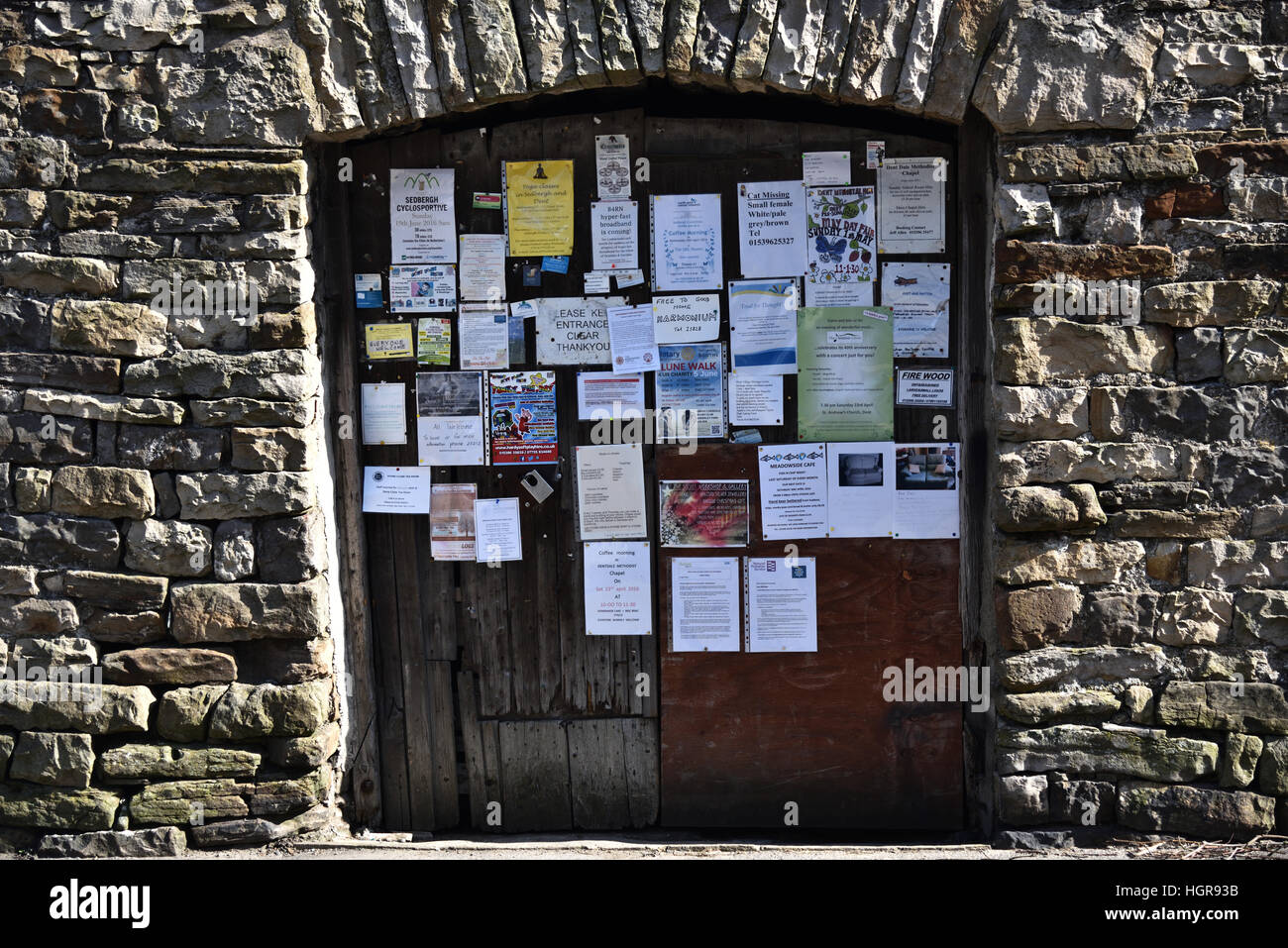 Notices pinned to wooden doors, Dent village, Yorkshire Dales National Park, Cumbria, England, UK. Stock Photo