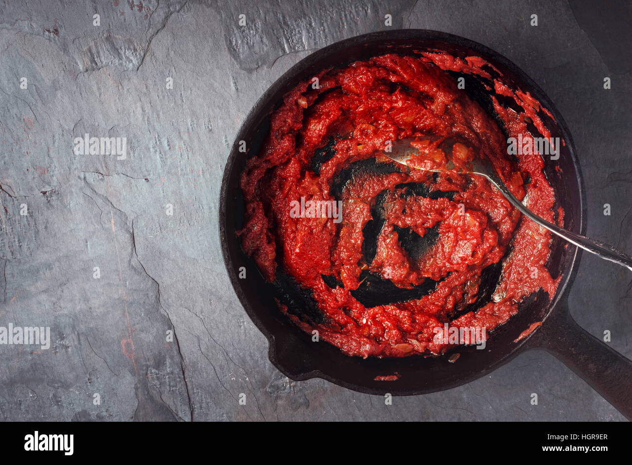 Tomato sauce on the pan on the stone background top view Stock Photo