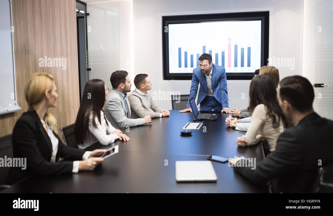 Business meeting and presentation in modern conference room for